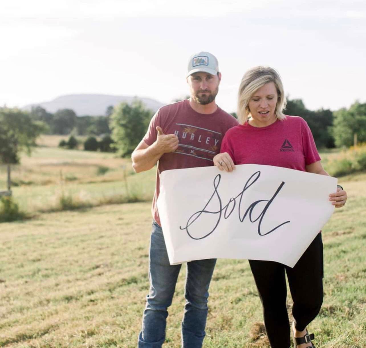 Happy clients with sold sign